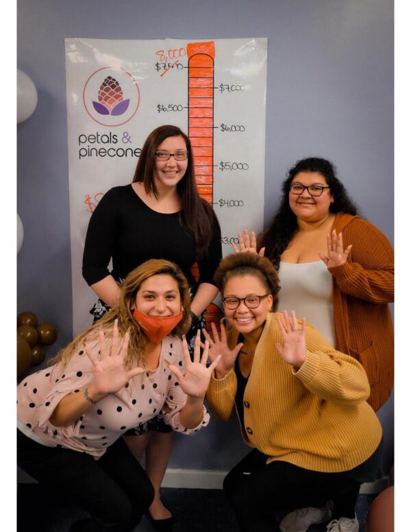 Michigan Mentorship Programs Help Young Women Succeed Petals and Pinecones alumni volunteering at a recent fundraiser.